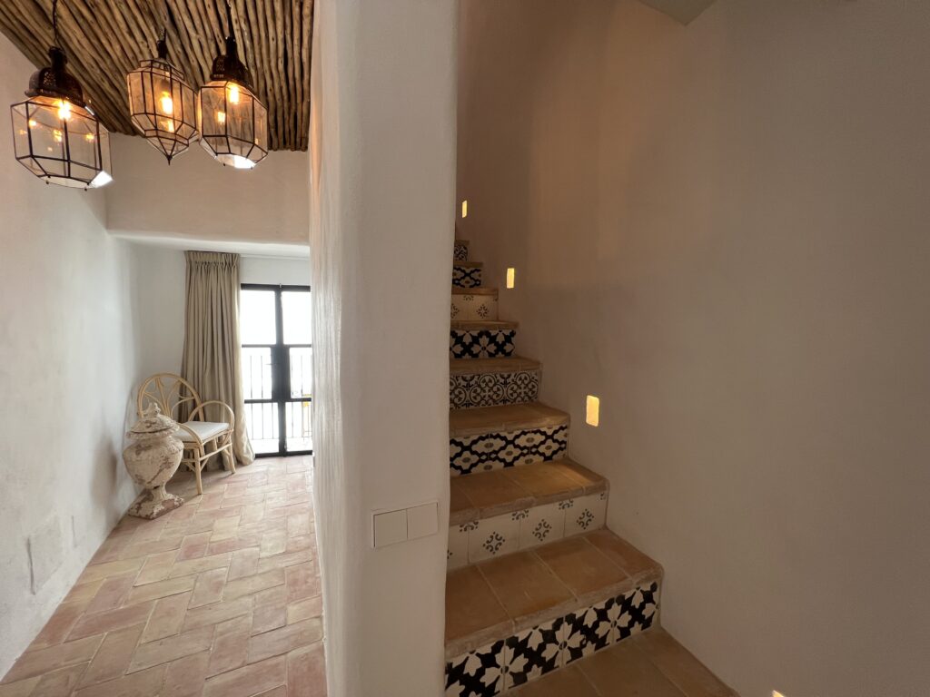 Traditional staircase with rustic lamp at Casa Aduar 22 Marbella Old Town