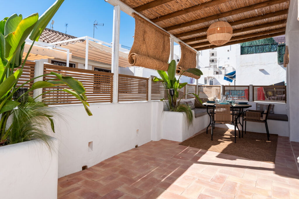 Rooftop terrace with dining table and chairs at Casa Aduar 22 Marbella Old Town