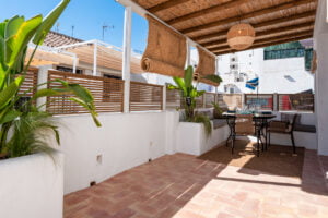 Rooftop terrace with dining table and chairs at Casa Aduar 22 Marbella Old Town