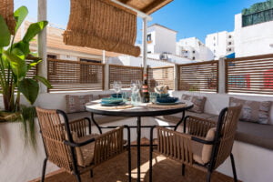 Rooftop terrace with dining table and chairs at Casa Aduar 22 Marbella Old Town