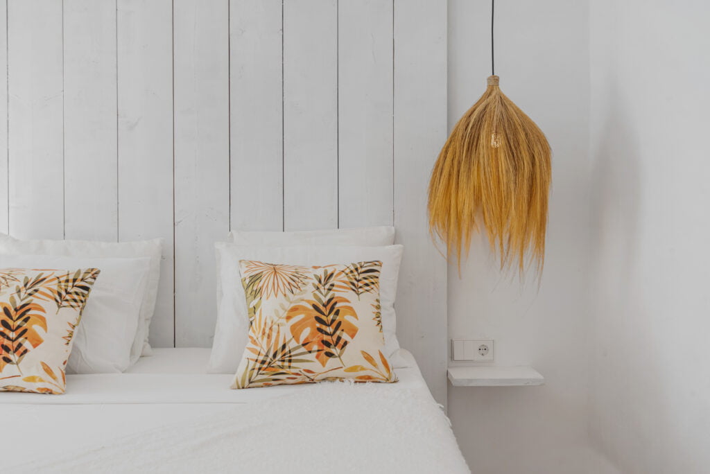 Sunlit double bedroom with rustic headboard at Casa Aduar 22