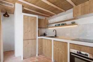 Rustic kitchen with shelves and wooden cabinets at Casa Aduar 22 Marbella Old Town