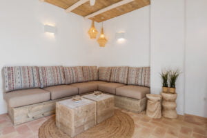 Rustic living room with beams and corner sofa at Casa Aduar 22 Marbella Old Town