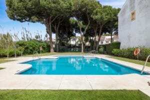 Communal swimming pool surrounded by pine trees – Jardín de los Pinos Marbella
