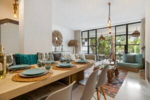 Dining area with wooden table and garden views – Jardín de los Pinos Marbella