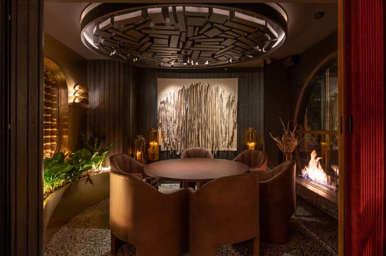 Interior of Leña Marbella restaurant, warm glowing steakhouse seating area