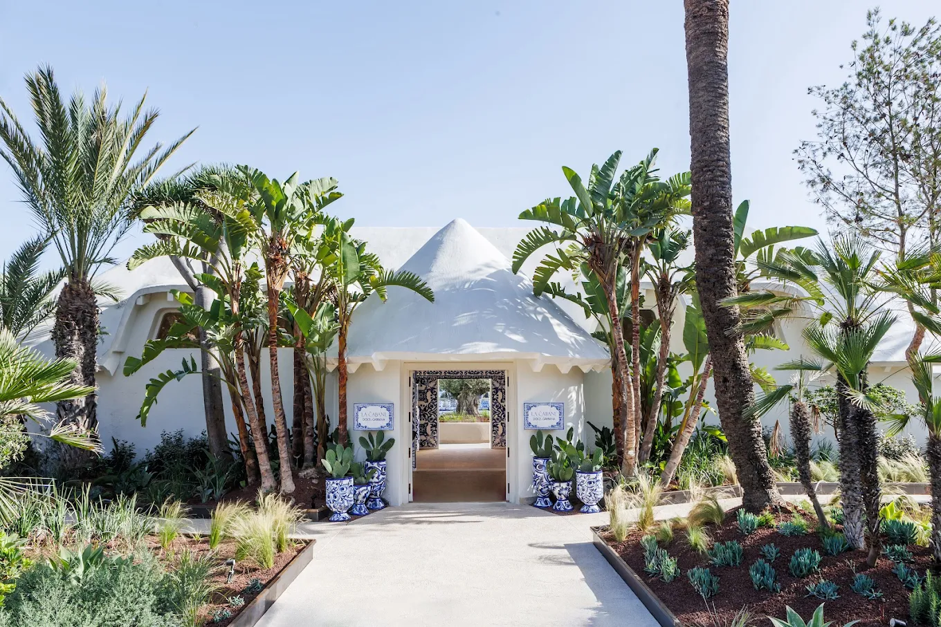 La Cabane Marbella beach club entrance with tropical garden and white architecture