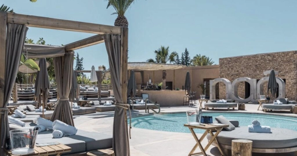 Nao Pool Club Marbella luxury pool area with sunbeds cabanas and swimming pool