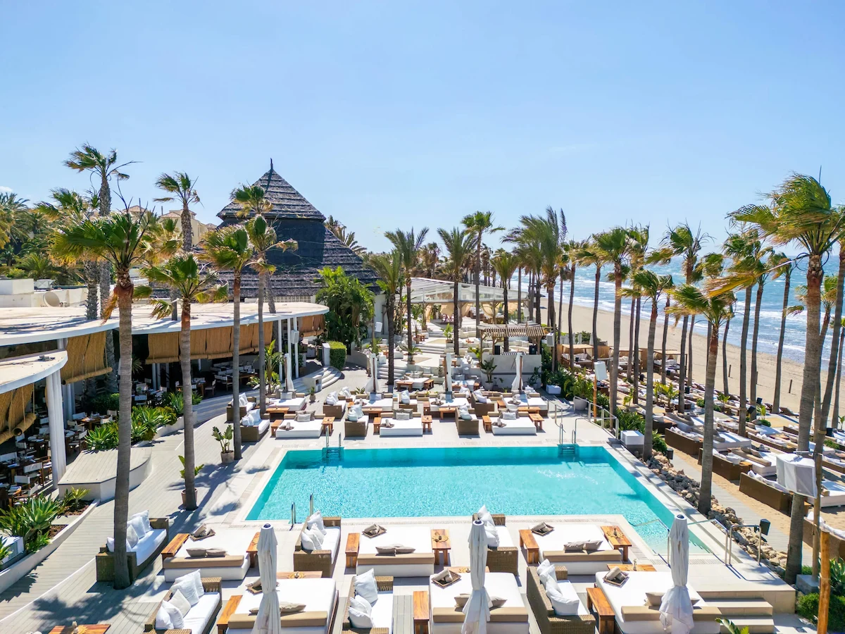 Nikki Beach Marbella luxury beach club with pool sunbeds and beachfront setting